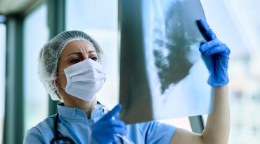 female-radiologist-analyzing-chest-xray-patient-medical-clinic-during-coronavirus-epidemic